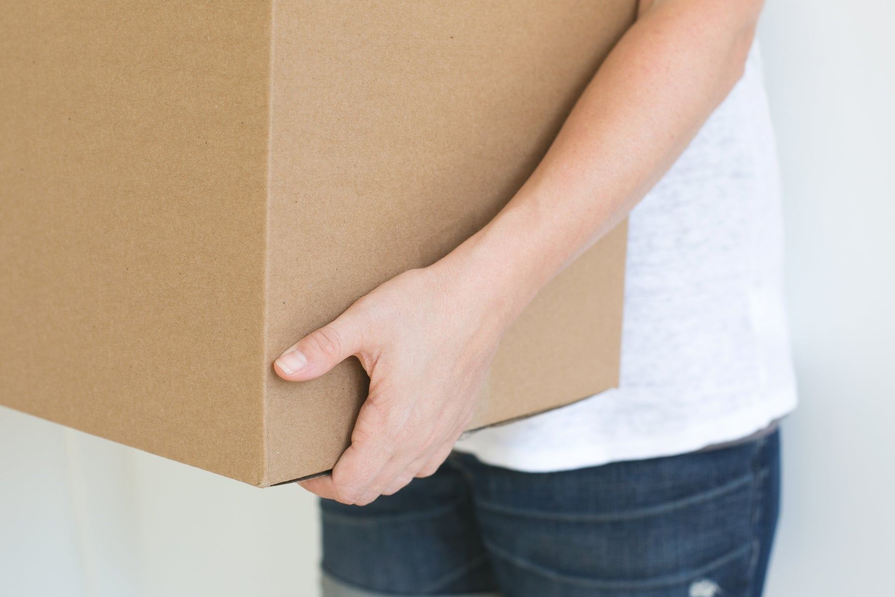 Someone carrying a cardboard box